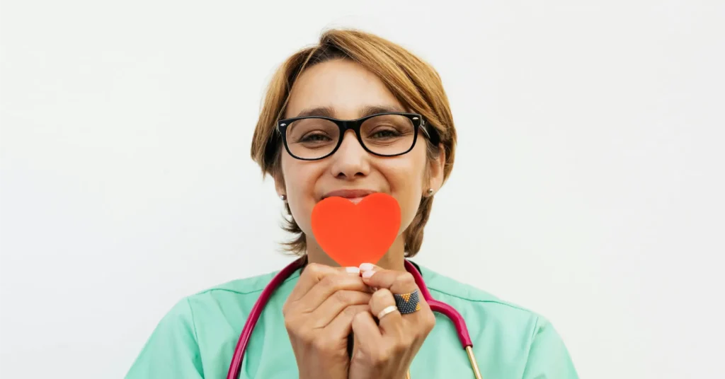 healthcare worker holding up heart