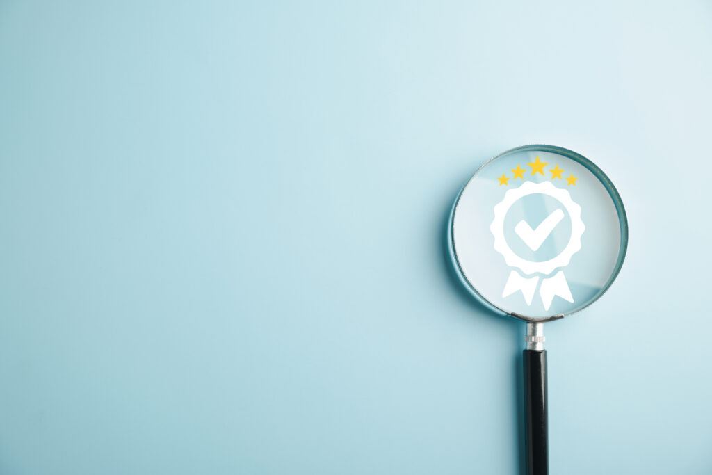 Magnifying glass on a table showing a certified ribbon