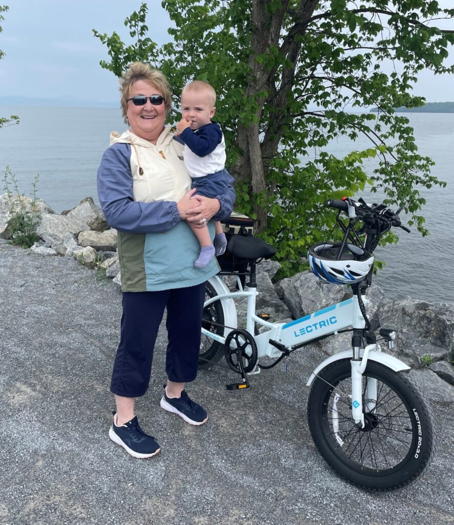 Woman holding a baby on a bike trail